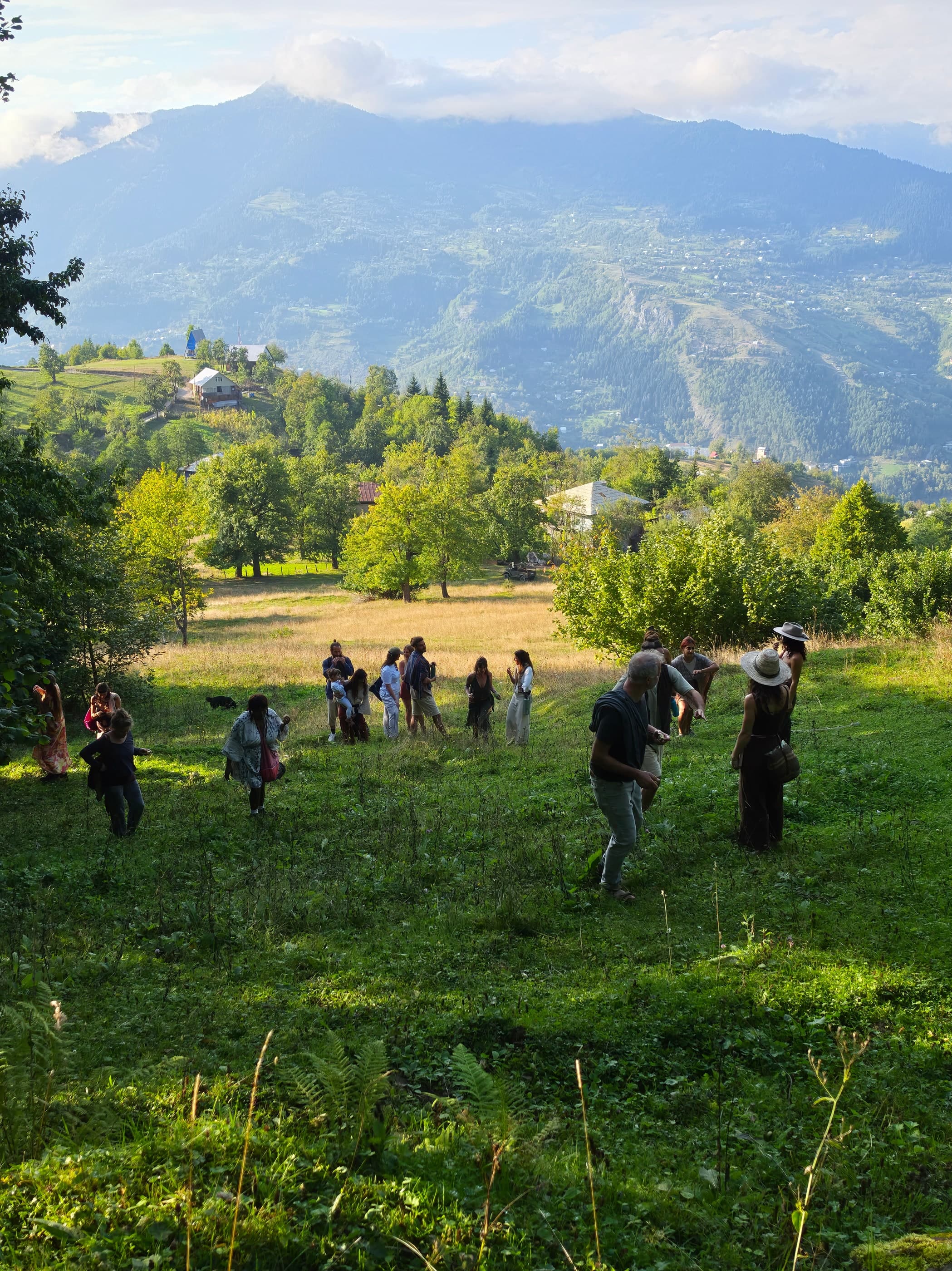 Guests enjoying an outdoor celebration in a scenic mountain landscape, Glamping Tago, Georgia.